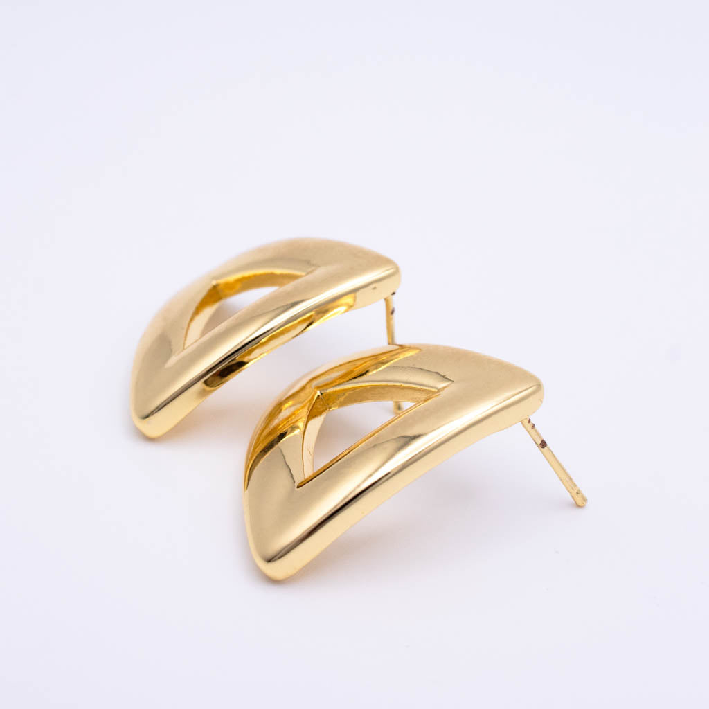 A pair of gold-toned geometric hoop earrings with open cutout details, displayed on a clean white background.