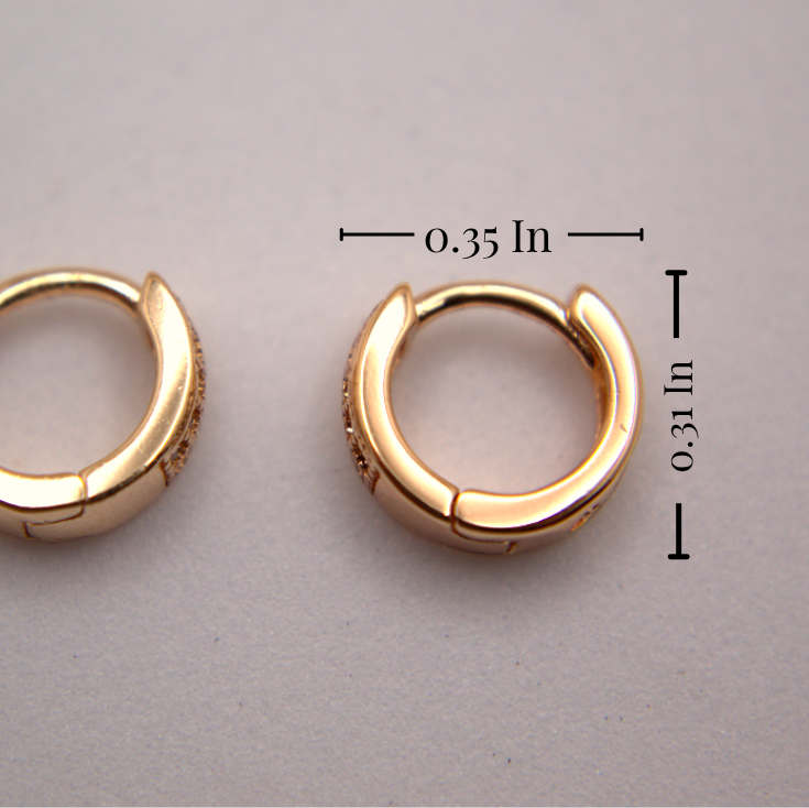 Gold hoop earrings with measurements on a gray background