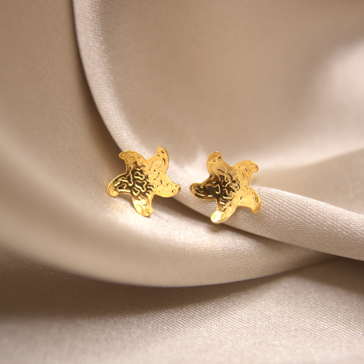 Minimal gold starfish earrings, beach-inspired jewelry.