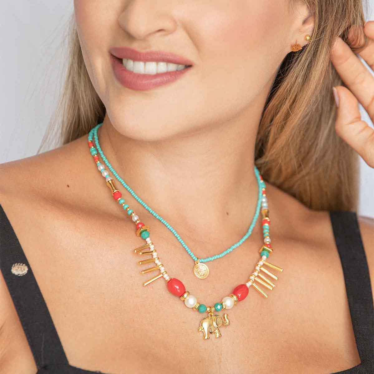 Woman wearing a colorful beaded necklace with gold accents