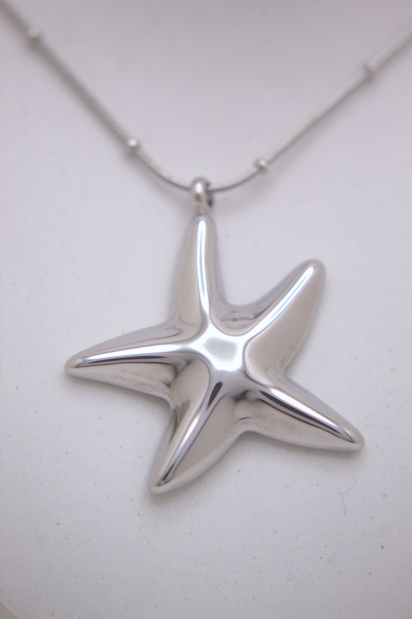 Ocean-inspired starfish pendant necklace in gold and silver finishes
