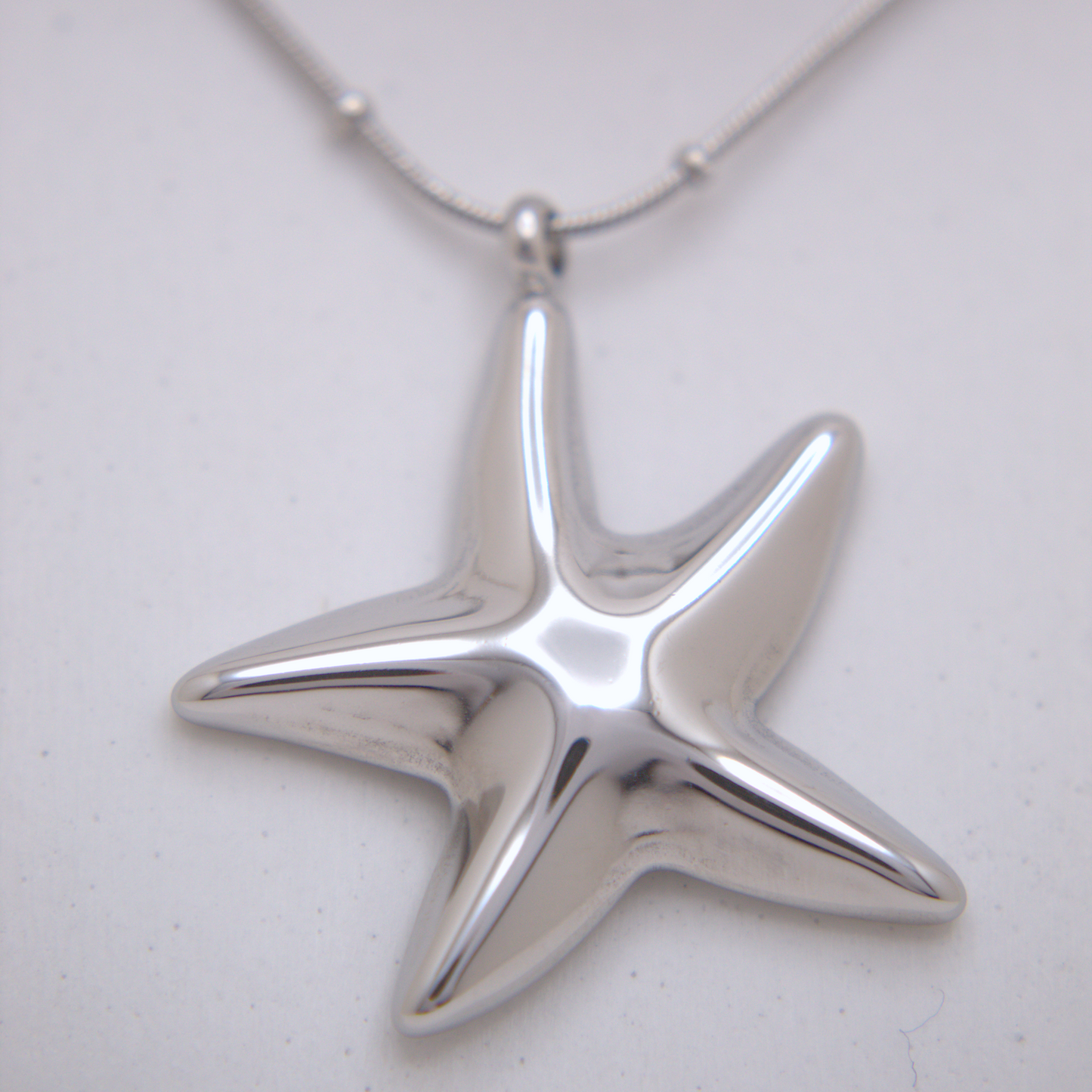 Ocean-inspired starfish pendant necklace in gold and silver finishes