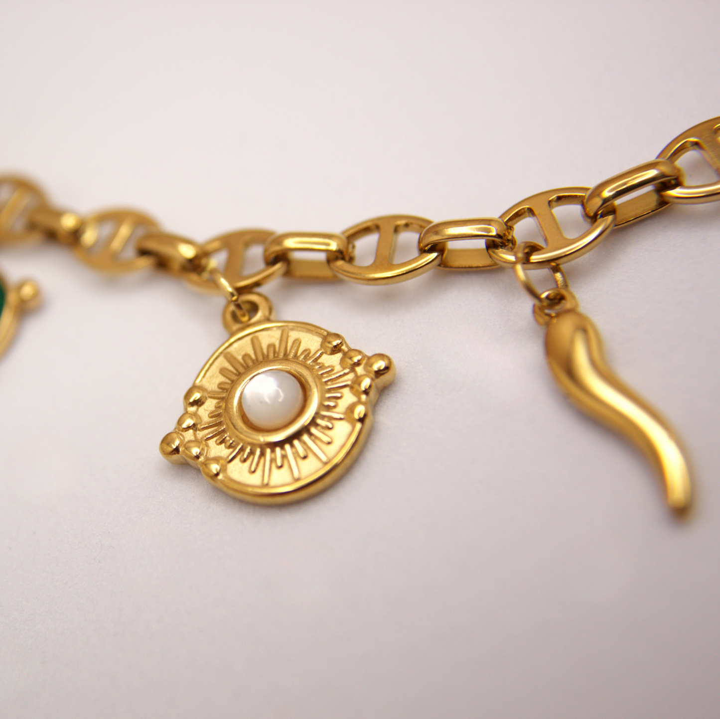 Statement gold charm necklace with amulet details, hypoallergenic PVD stainless steel.