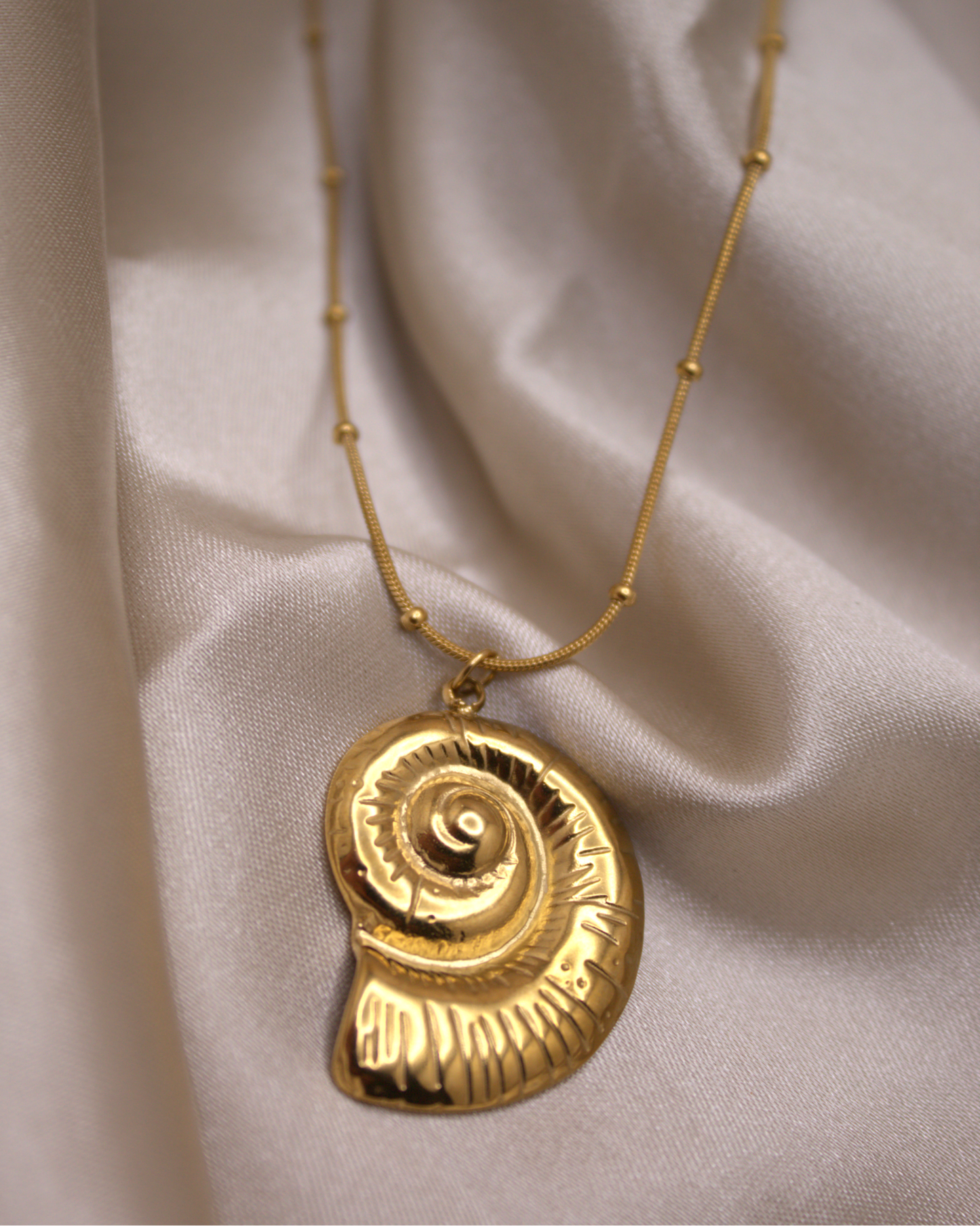 Gold stainless steel necklace featuring seashell pendant by Selva Accessories