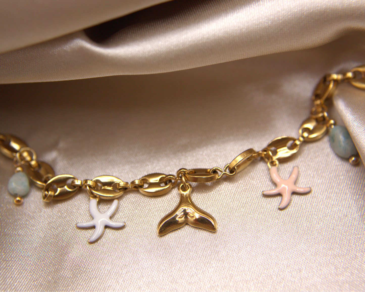 Sea Whisper Bracelet in gold with whale tail, starfish, and natural stone charms