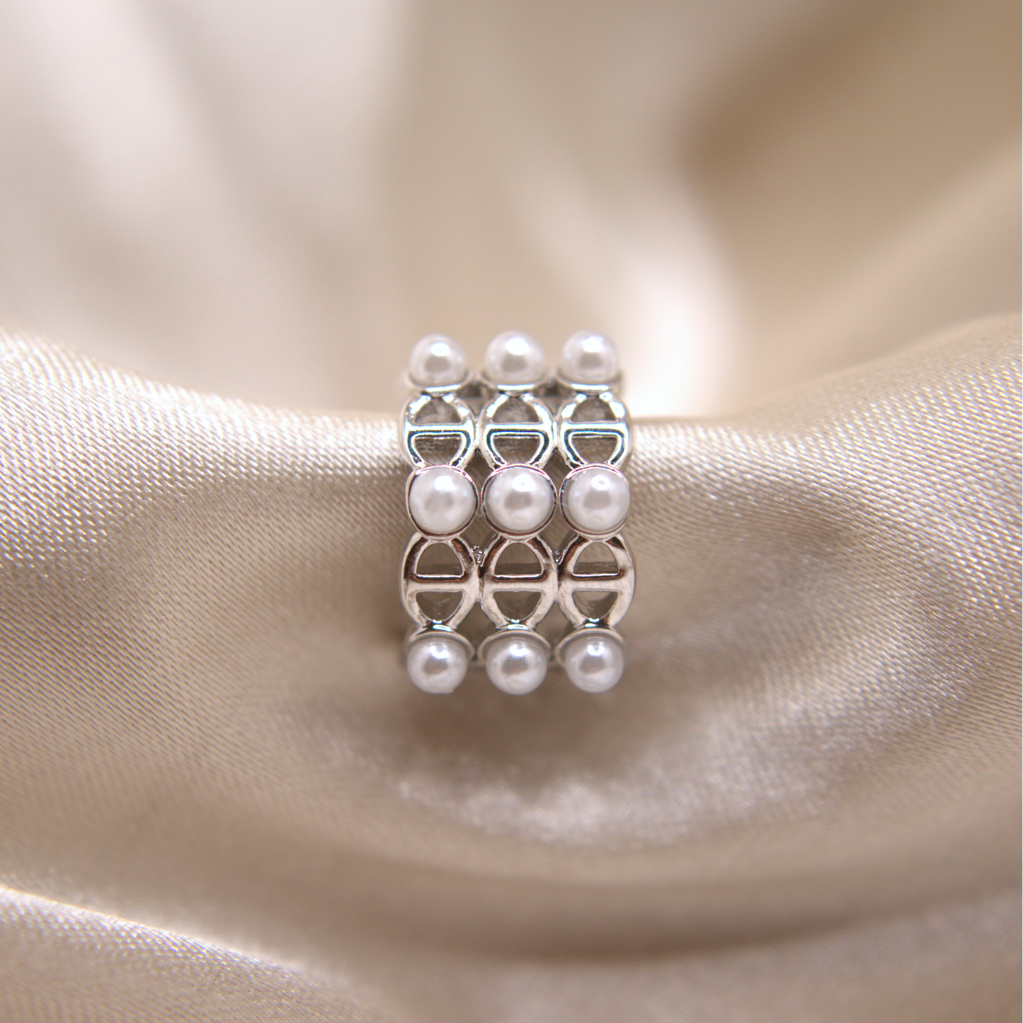 Dual-tone ear cuff in gold and silver with pearl accents.