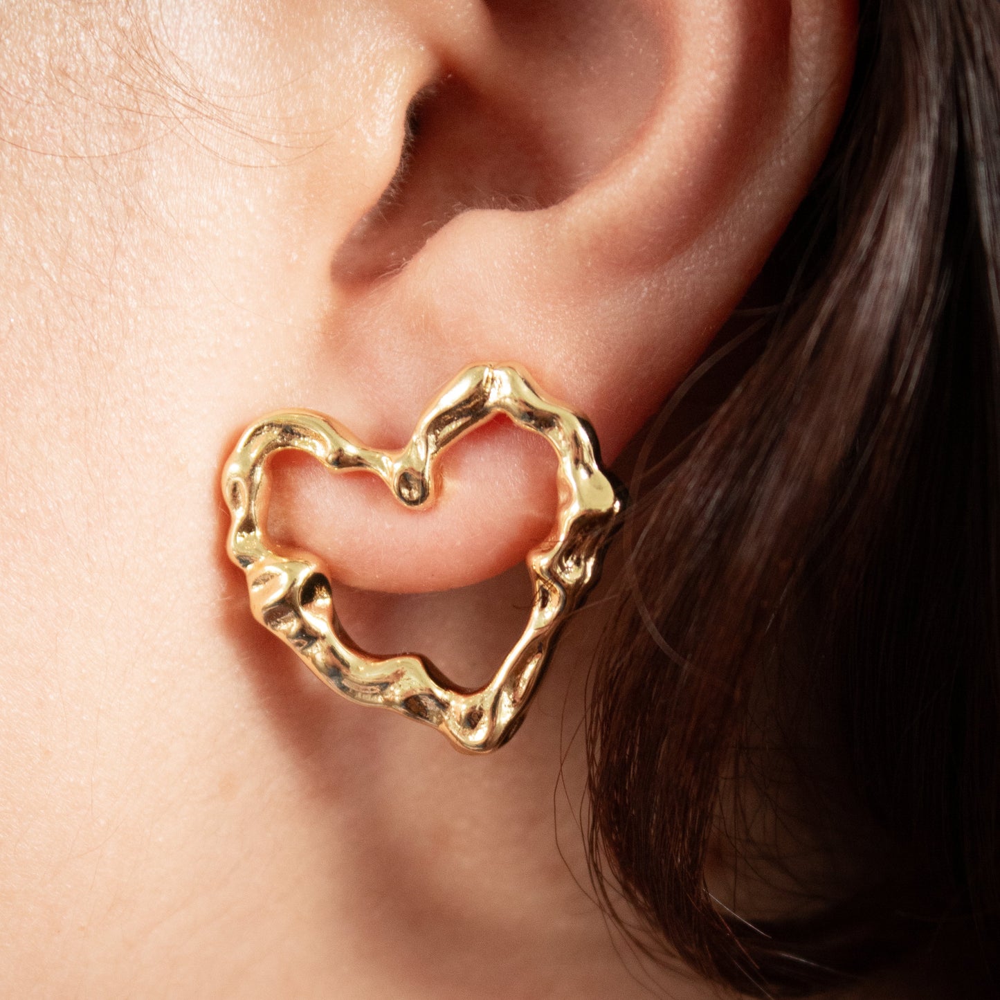 Modern organic heart studs in high-shine gold finish