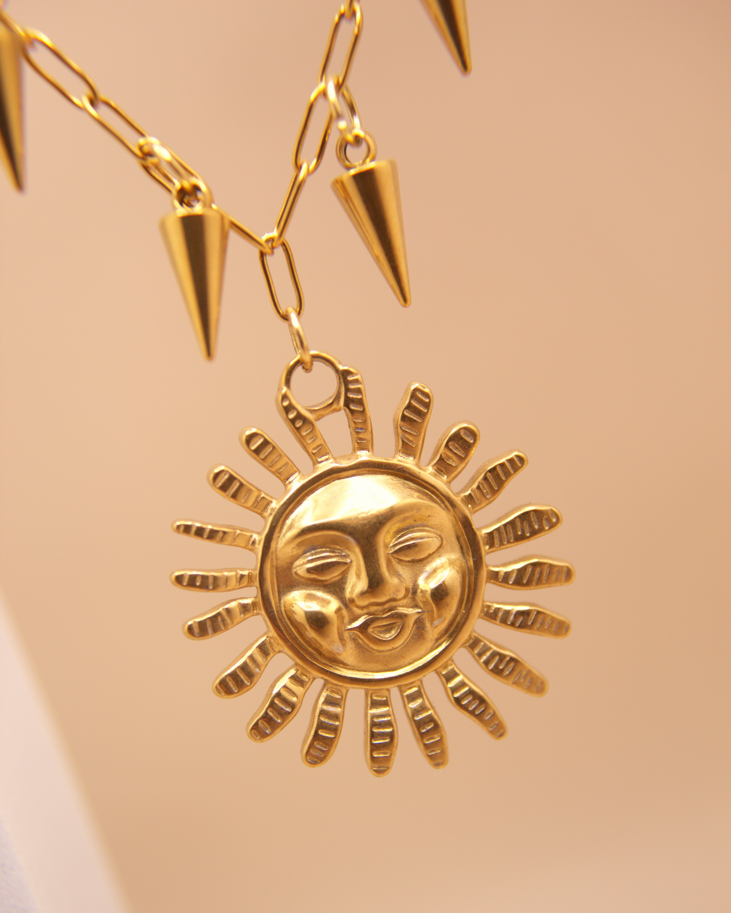 Statement gold sun necklace featuring edgy spike pendants, waterproof stainless steel.
