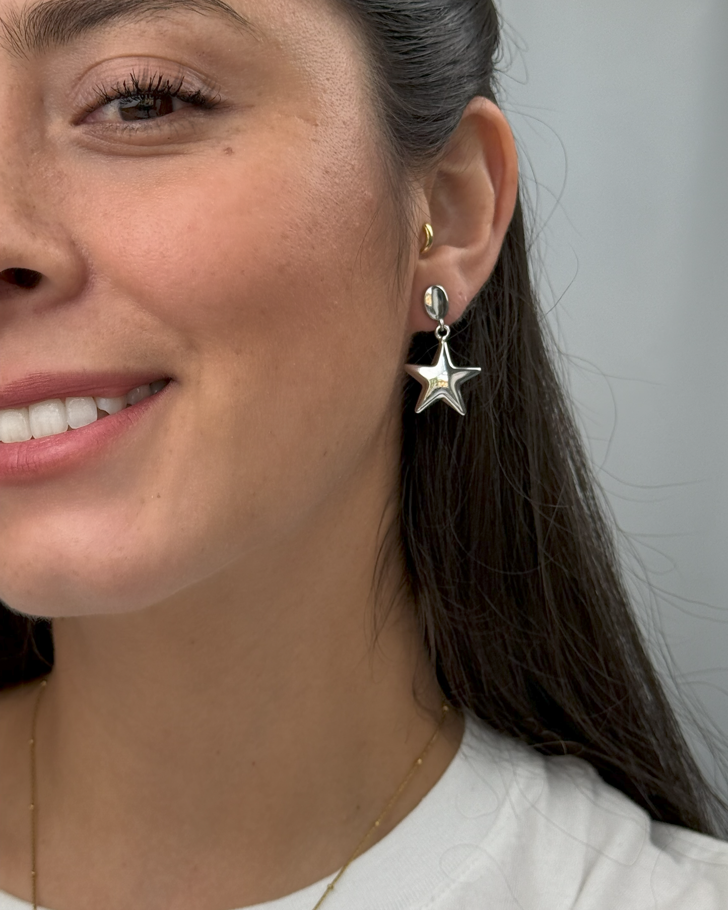 Shiny rhodium plated stud earrings with gold and silver star drops