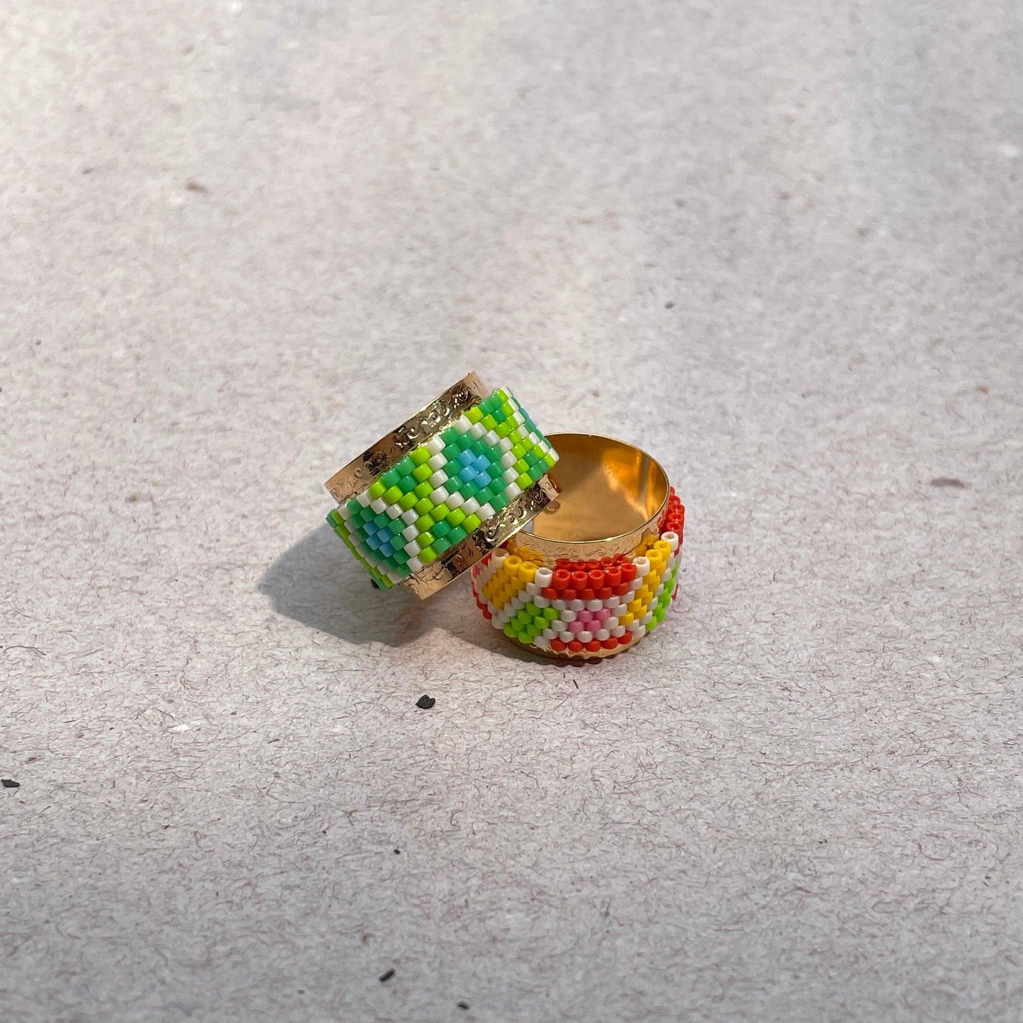 Colorful beaded ring on a light gray surface