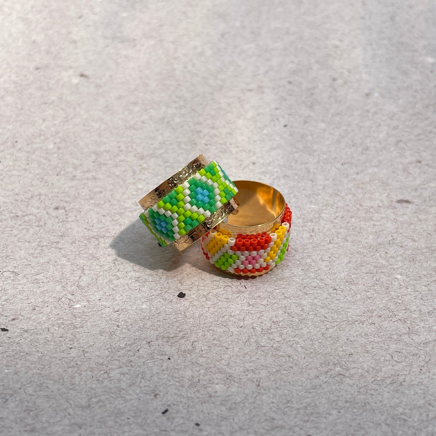 Colorful beaded ring on a light gray surface