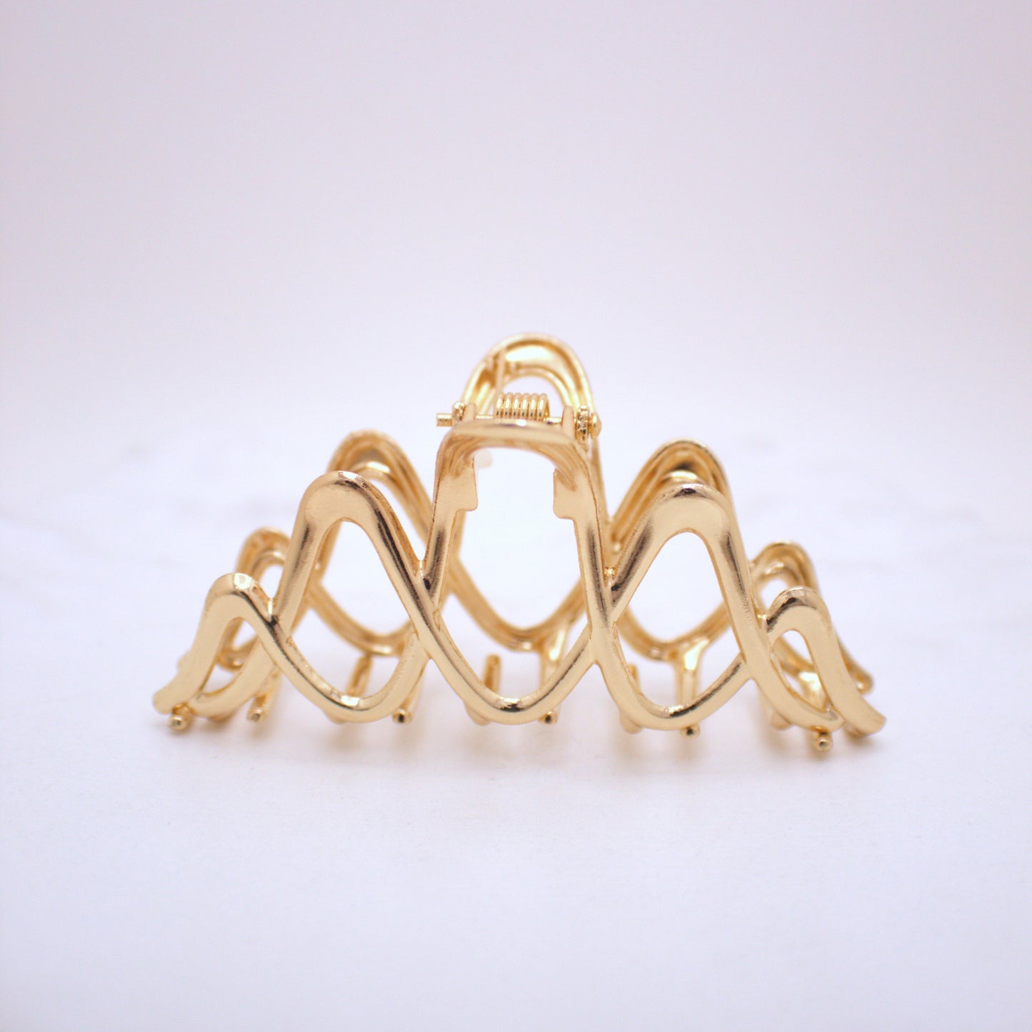 Gold hair clip on a white background