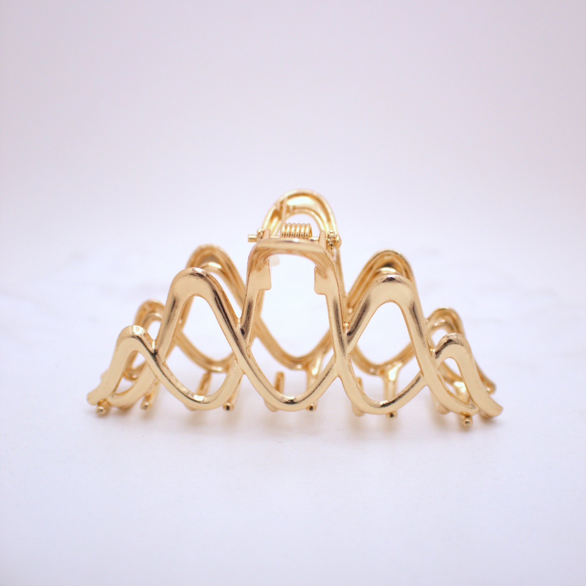 Gold hair clip on a white background