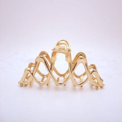 Gold hair clip on a white background