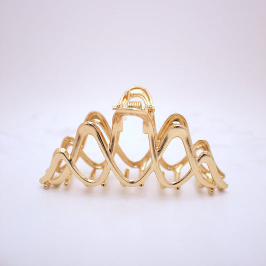 Gold hair clip on a white background