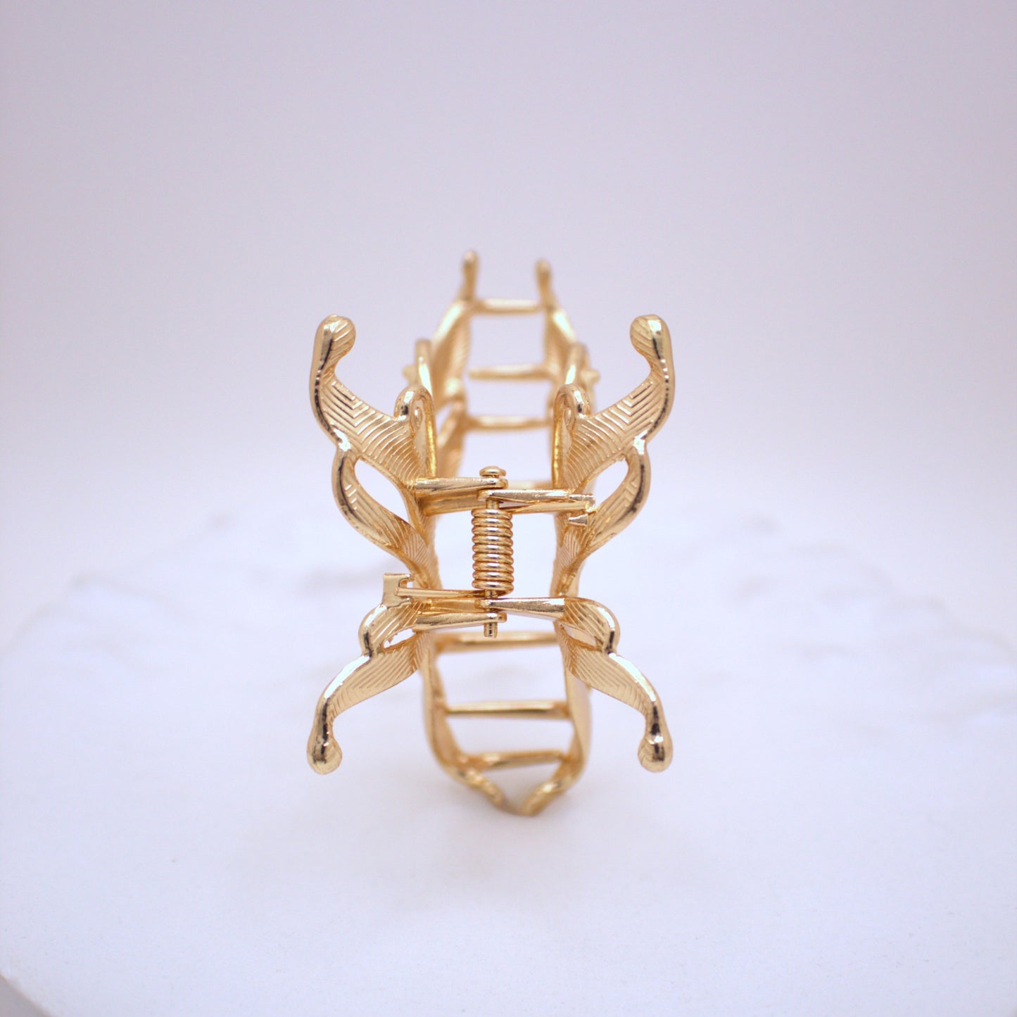 Gold hair clip on a white background
