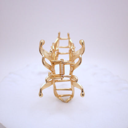 Gold hair clip on a white background