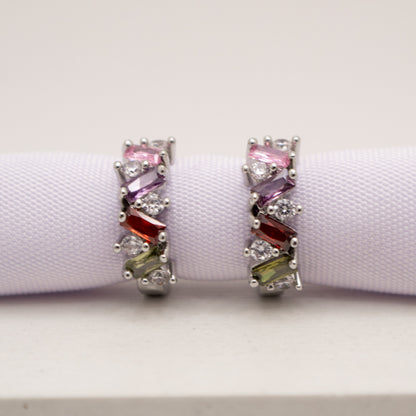 Pair of earrings with colorful gemstones on a white background