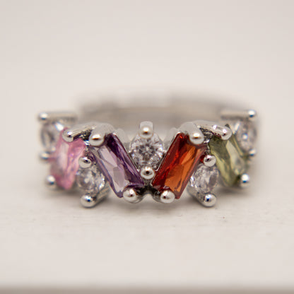 Ring with multicolored gemstones on a light background