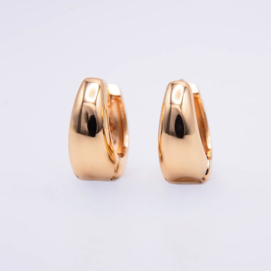 A pair of polished rose gold huggie hoop earrings shown from a side profile view against a clean, light gray background.