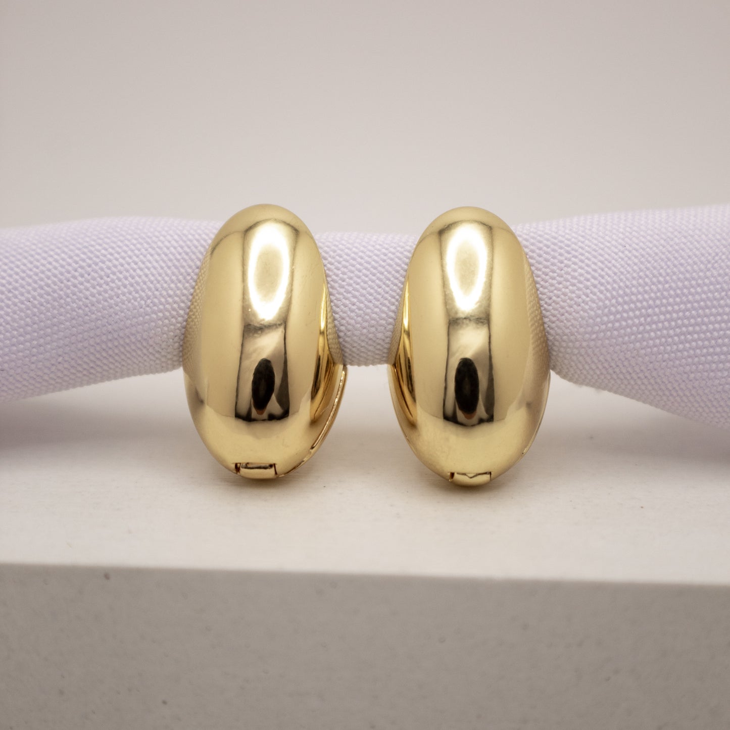 Pair of gold hoop earrings on a white background
