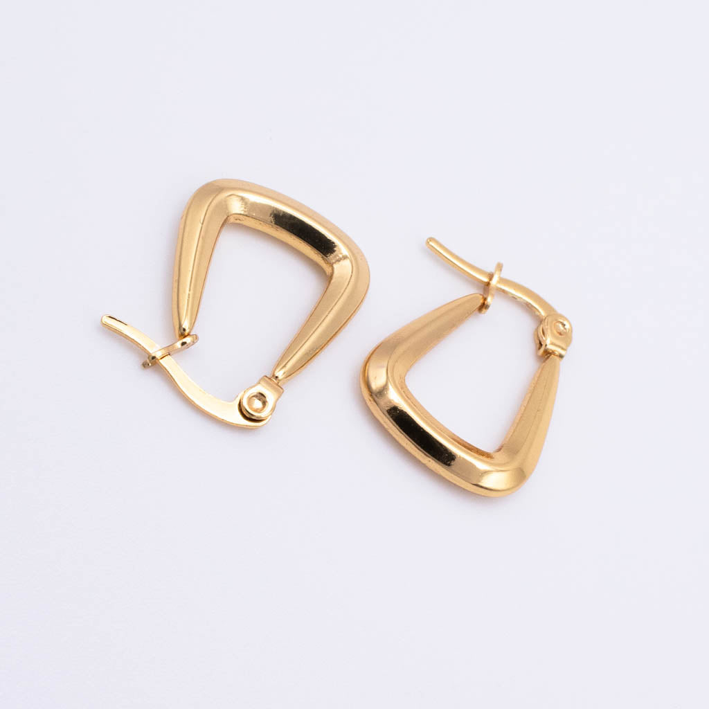 A pair of gold-toned geometric hoop earrings with a polished finish, displayed on a clean white background.