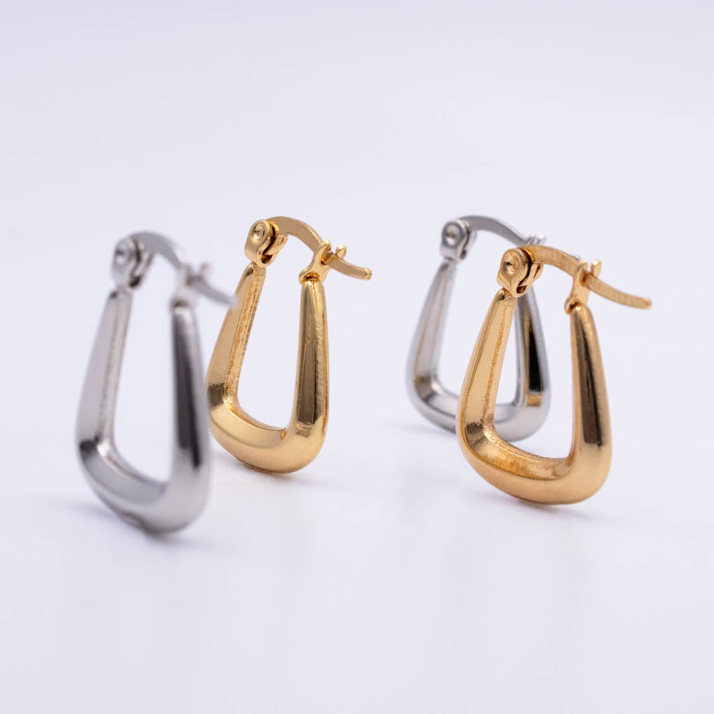 Three small hoop-style earrings on a clean white background, including two gold-toned and one silver-toned pair.