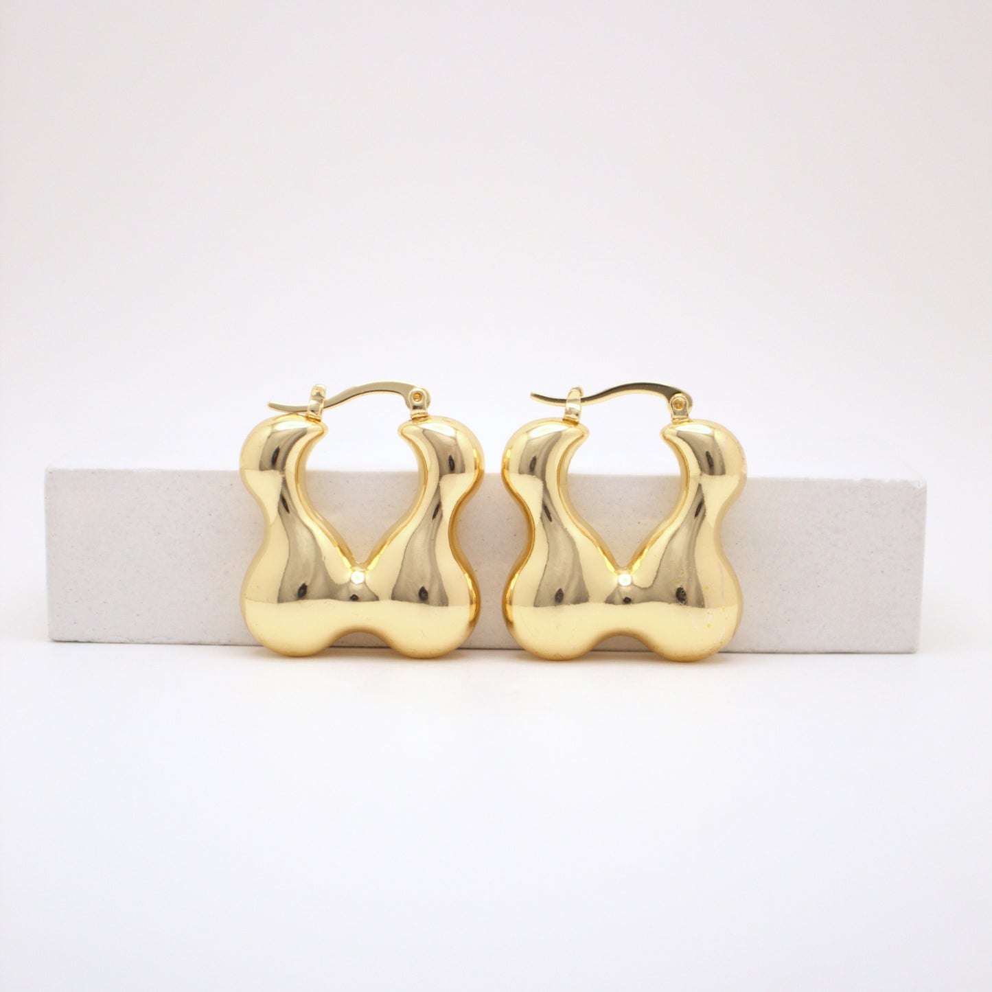 Gold hoop earrings on a white background