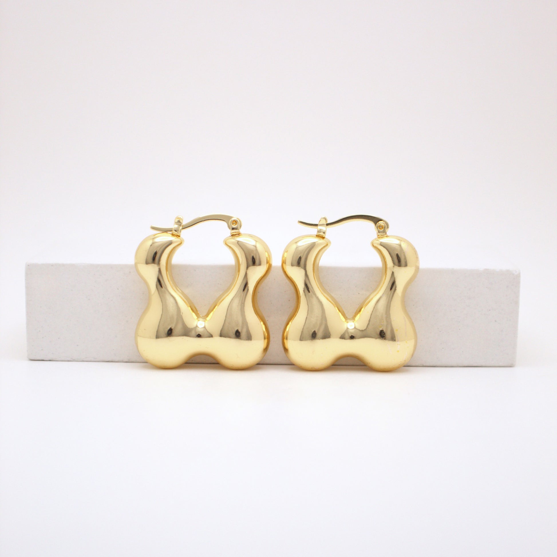 Gold hoop earrings on a white background