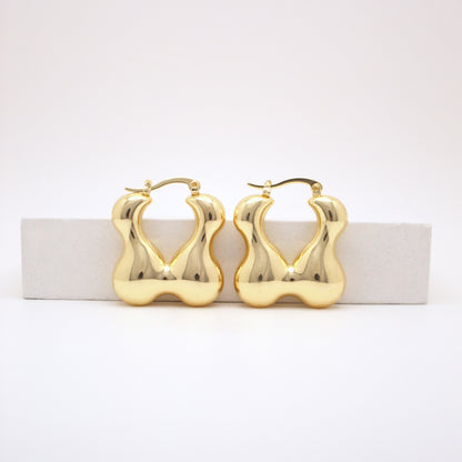 Gold hoop earrings on a white background