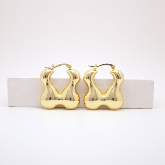 Gold hoop earrings on a white background