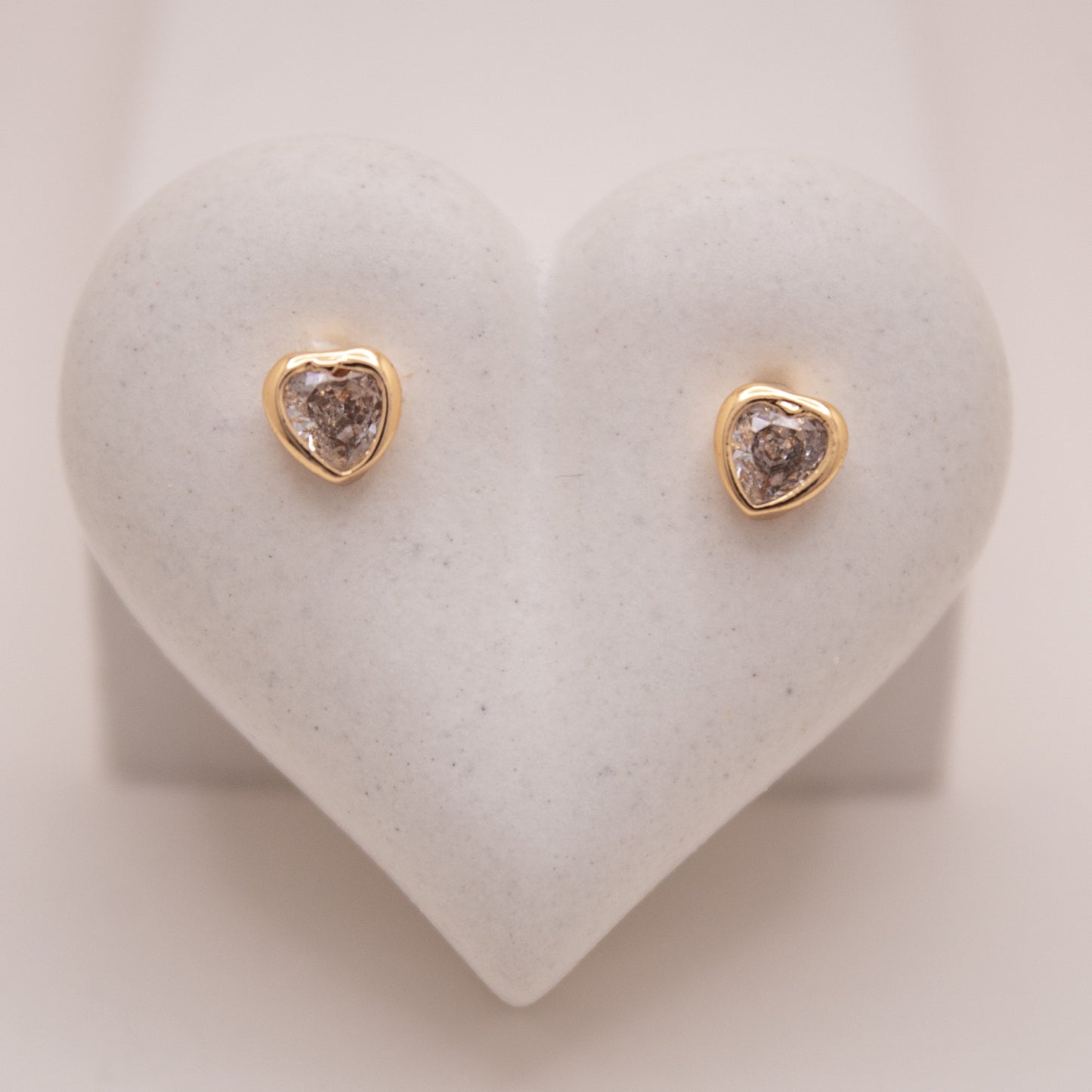 Gold heart stud earrings with high-shine finish by Selva&Co.