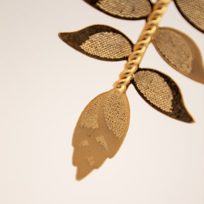 Close-up of a gold leaf design on a beige background