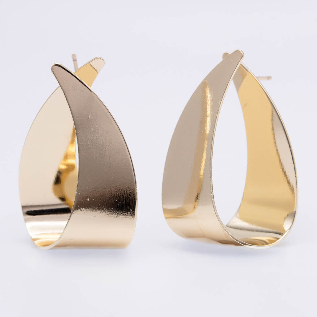 A pair of gold teardrop-shaped hoop earrings with a polished, reflective finish, displayed on a clean white background.