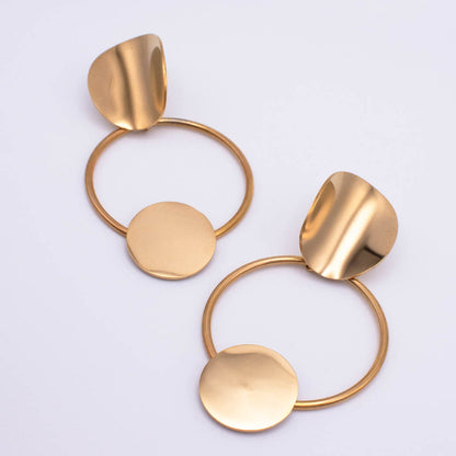 A pair of modern gold-toned dangle earrings with circular hoops, flat round discs, and organic leaf-like top pieces, photographed on a clean white background.
