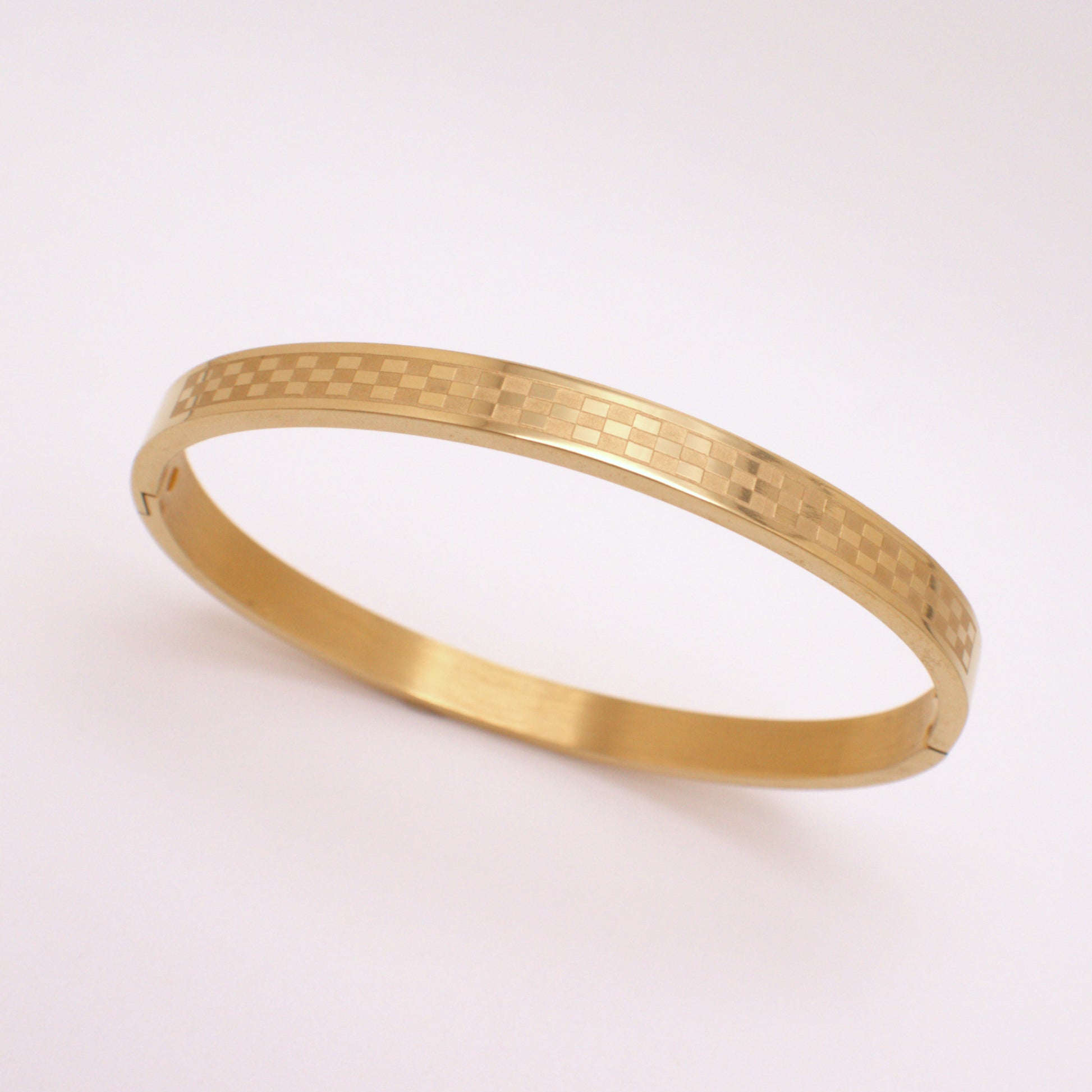 Gold bracelet on a white background