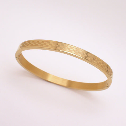 Gold bracelet on a white background