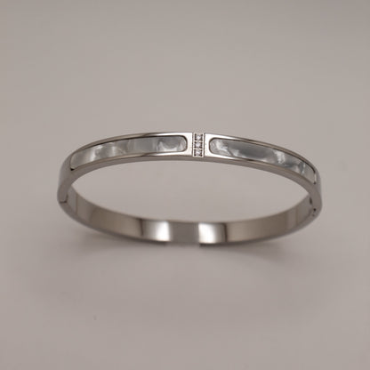 Silver bracelet on a light gray background