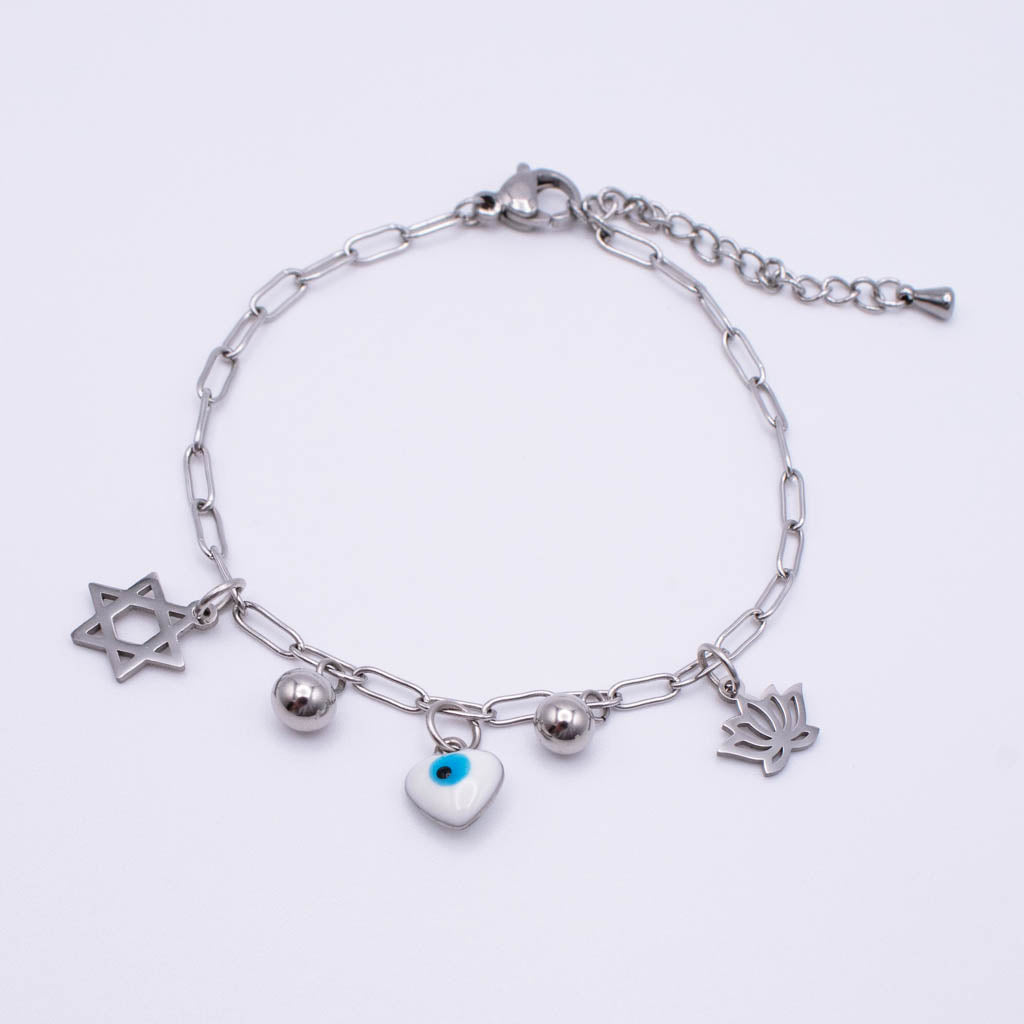 A silver paperclip chain bracelet with four charms:  an evil eye heart, a mezuzah, and a small silver bead, displayed on a clean white background.