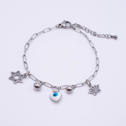 A silver paperclip chain bracelet with four charms:  an evil eye heart, a mezuzah, and a small silver bead, displayed on a clean white background.