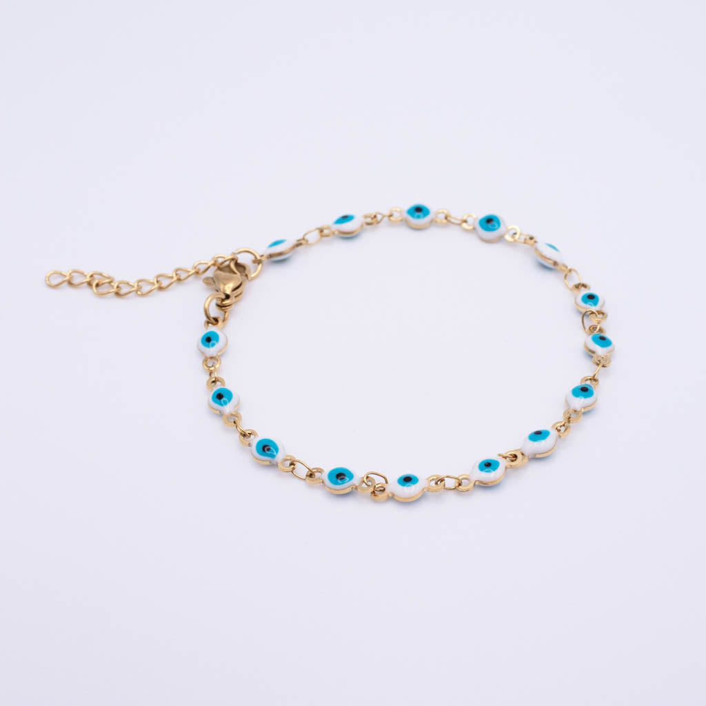 Gold chain bracelet with multiple evil eye charms featuring turquoise blue centers and white borders, displayed on a clean white background.