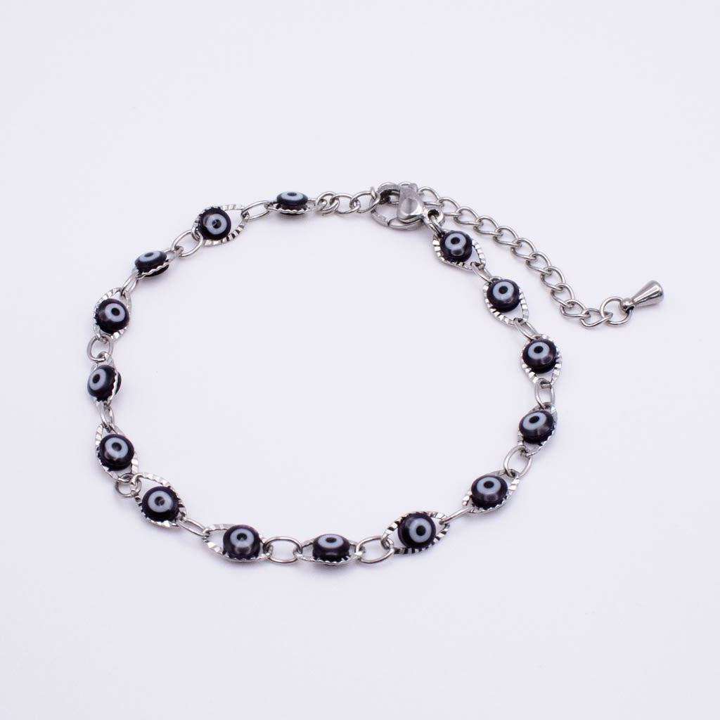 A silver-toned chain bracelet featuring multiple evil eye bead charms with black, white, and blue details, displayed on a clean white background.