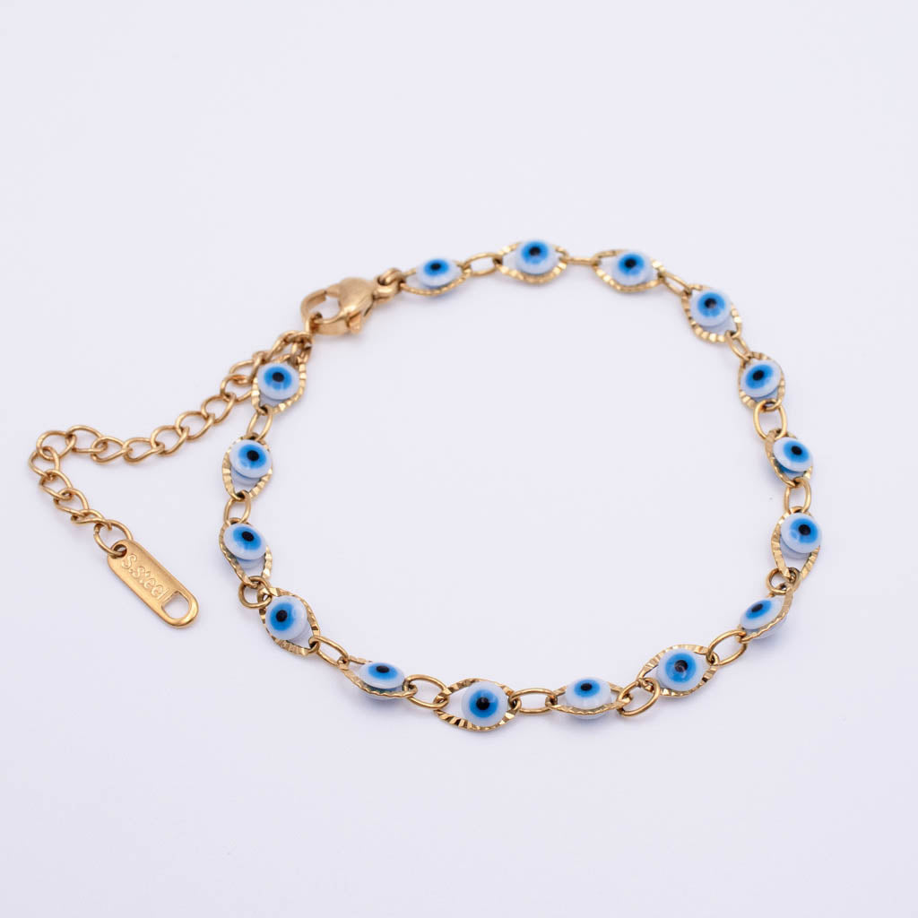 Gold chain bracelet with multiple oval blue and white evil eye charms, displayed on a clean white background.