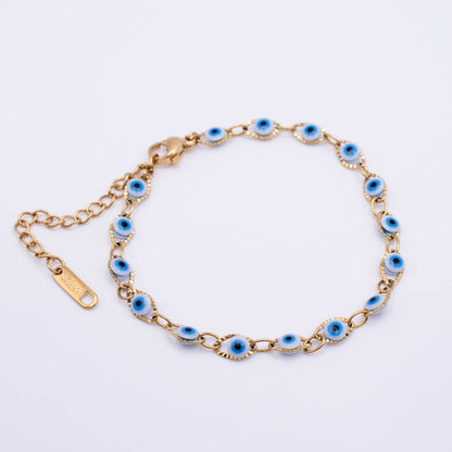 Gold chain bracelet with multiple oval blue and white evil eye charms, displayed on a clean white background.
