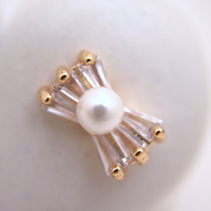 Pearl brooch with gold accents on a white background
