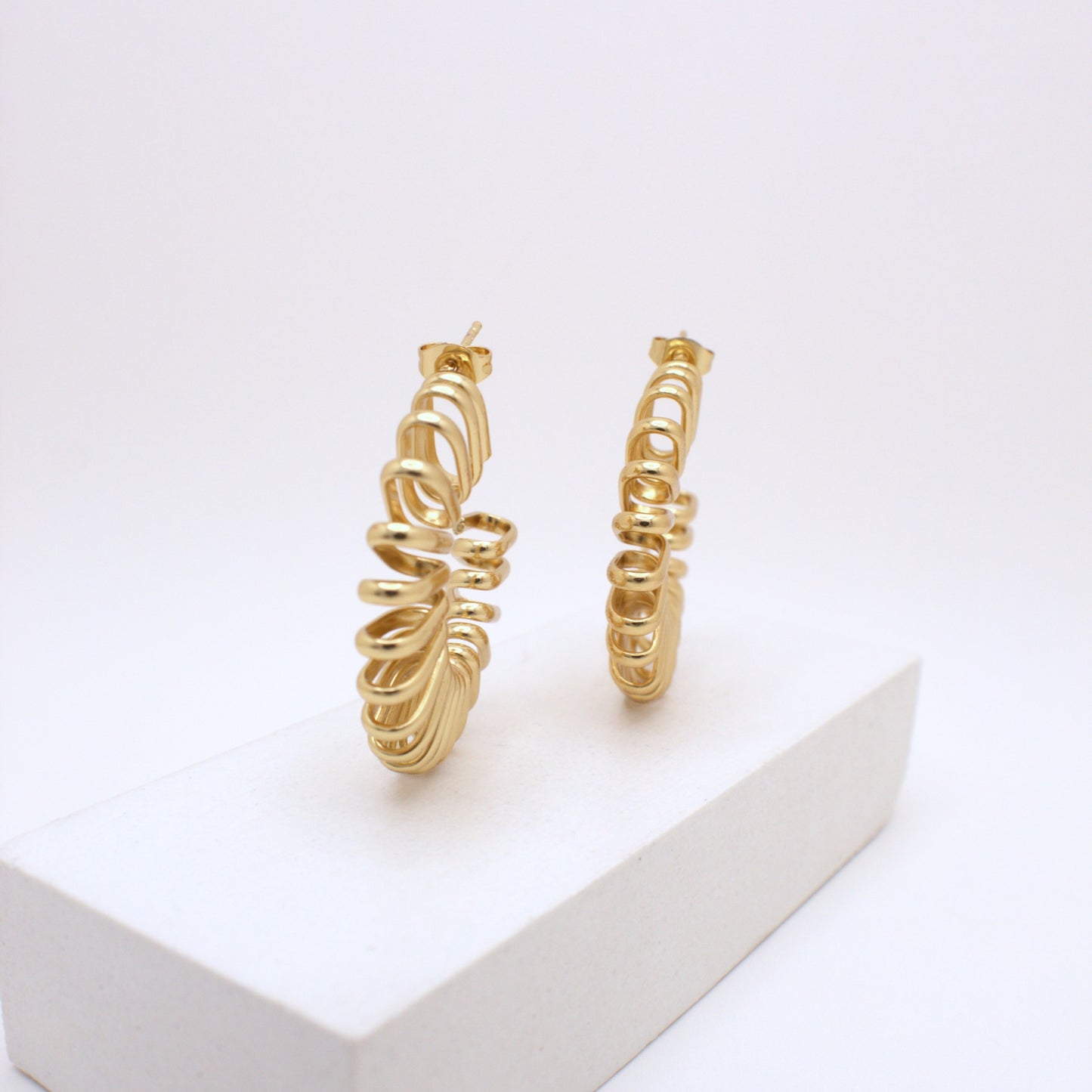 Gold hoop earrings on a white background