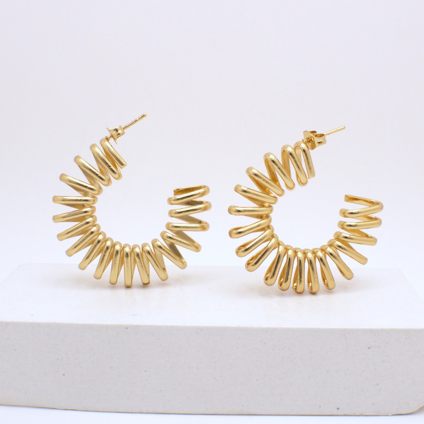 Gold hoop earrings on a white background