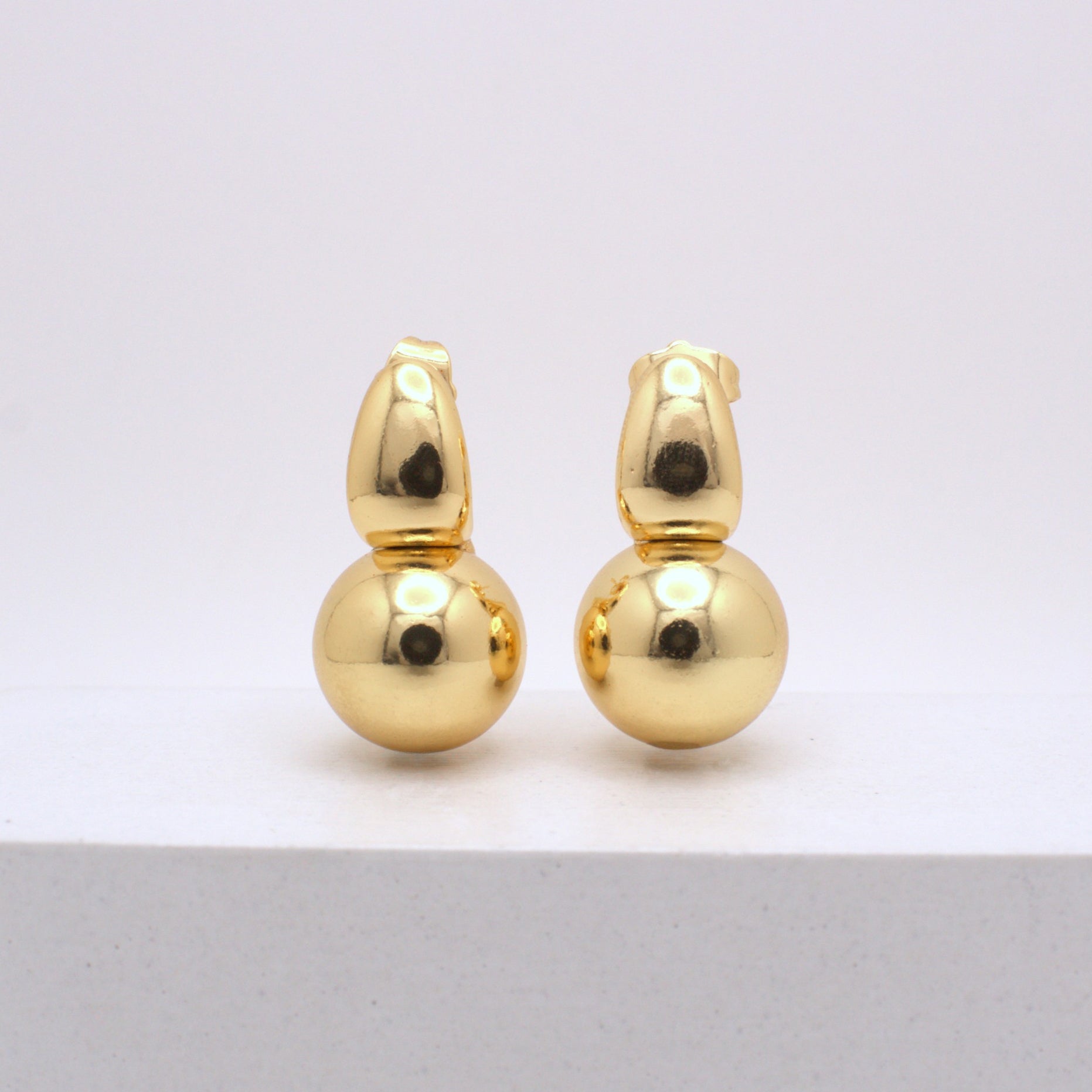 Pair of gold earrings on a white background