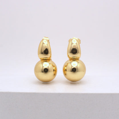 Pair of gold earrings on a white background