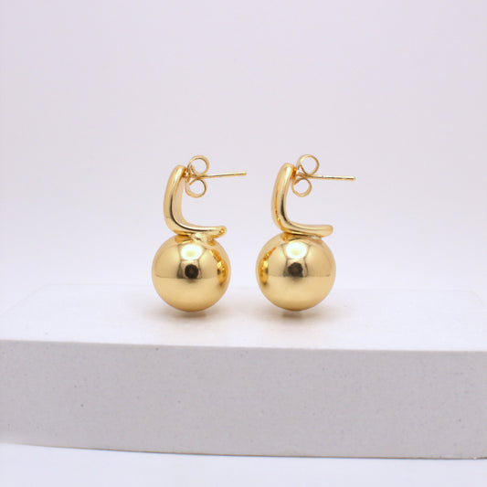 Pair of gold hoop earrings on a white background